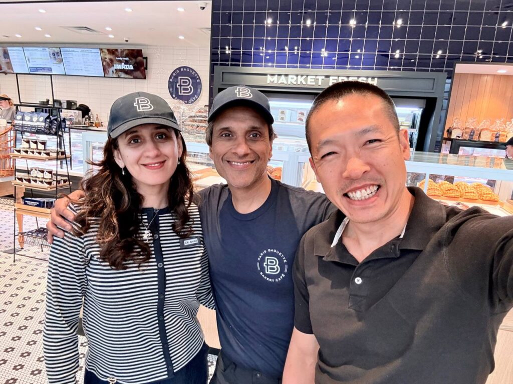 Di Tran posing with the owner couple inside Louisville’s first Paris Baguette in Kentucky.
